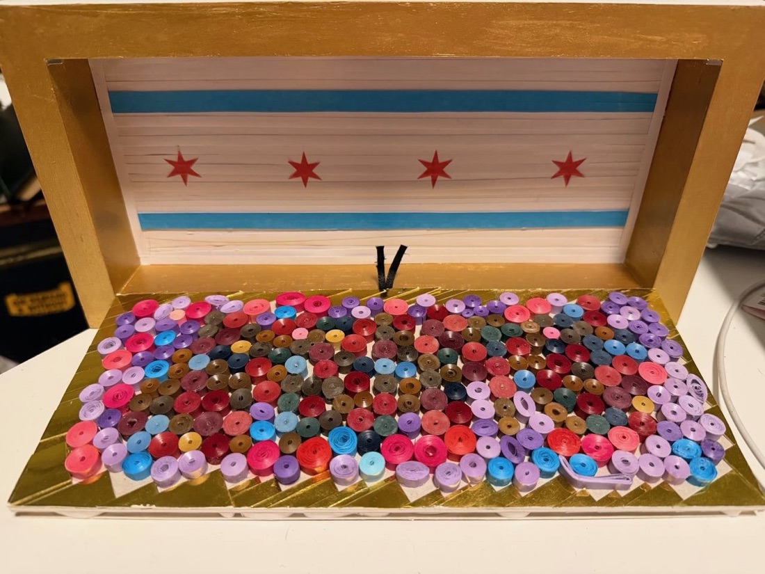 The quilled box opened, showing a paper Chicago flag inside the lid above a tray of colourful paper coils