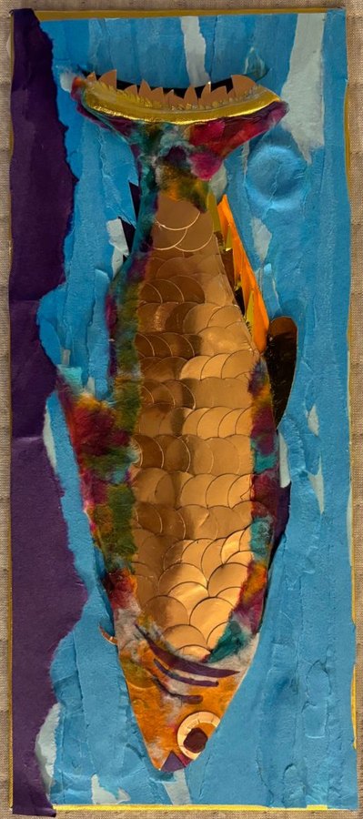A salmon made of overlapping gold foil scales, edged in torn magenta, green and orange tissue, swimming up through torn blue paper water on a tall narrow panel